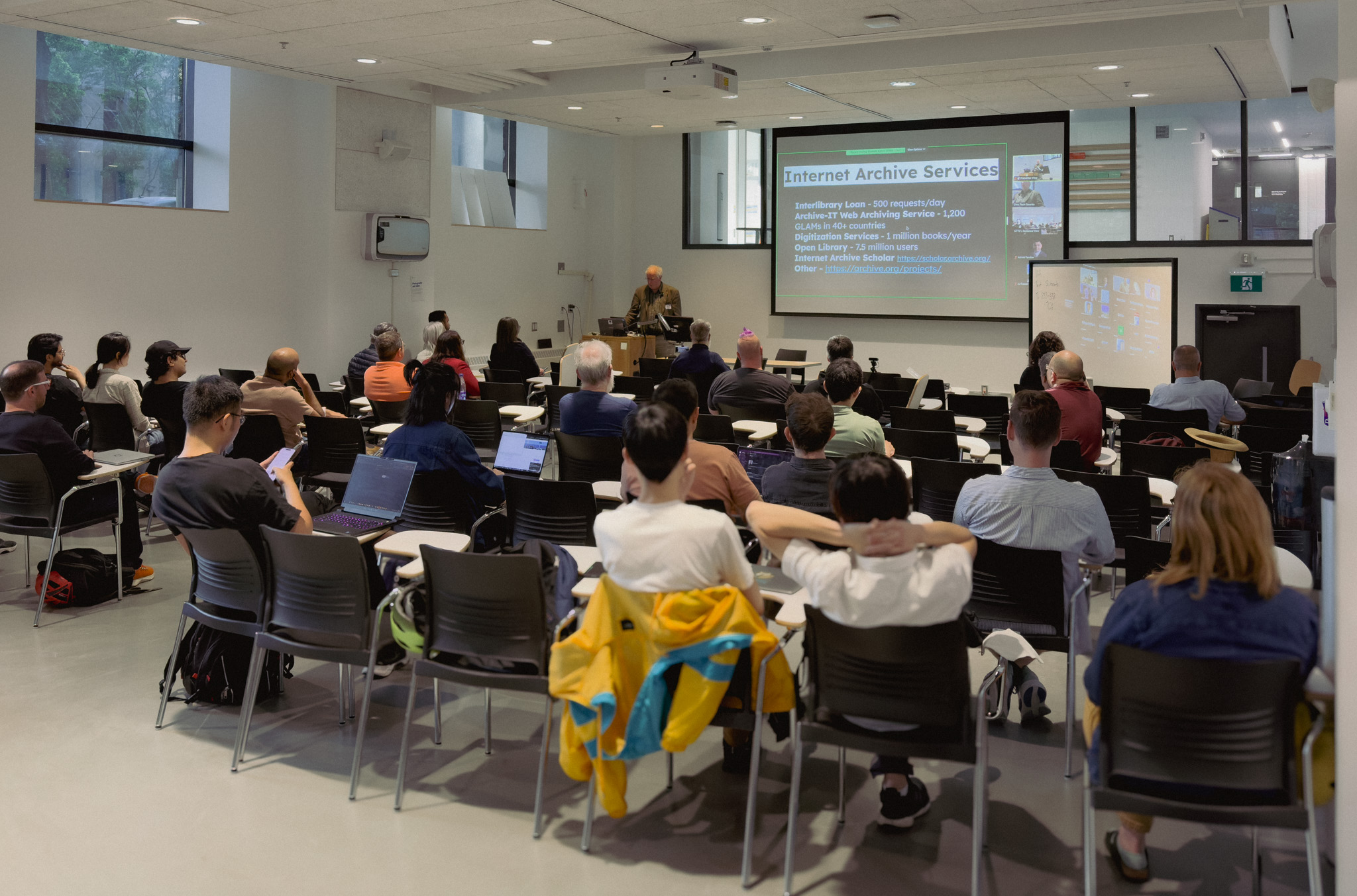 Picture of a group of people sitting listening to a presentation at a Civic Tech Toronto Hacknight